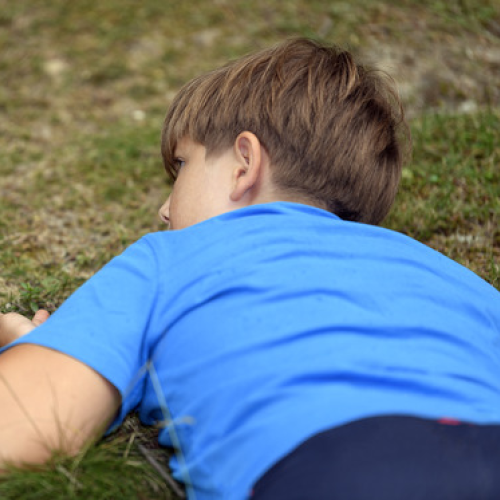 Young boy watching closely a columbian ground squirrel (Urocitellus columbianus)